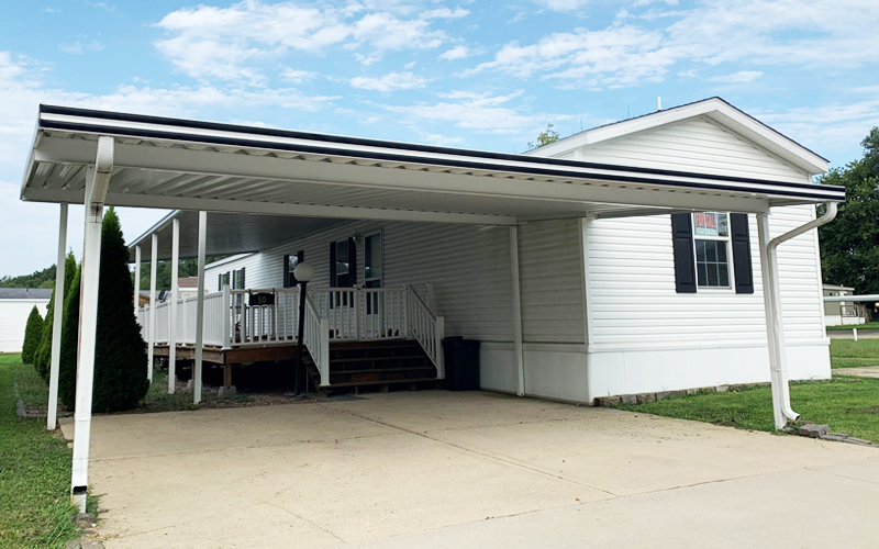 mobile home with carport and porch