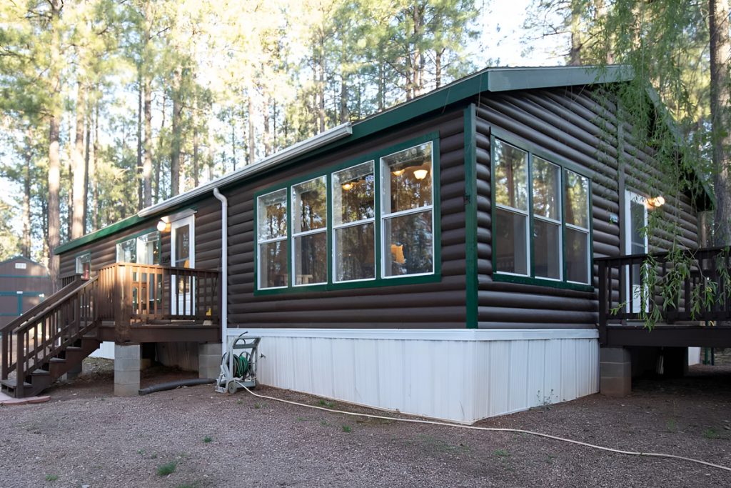 Mobile Home with Black Log Wood Siding