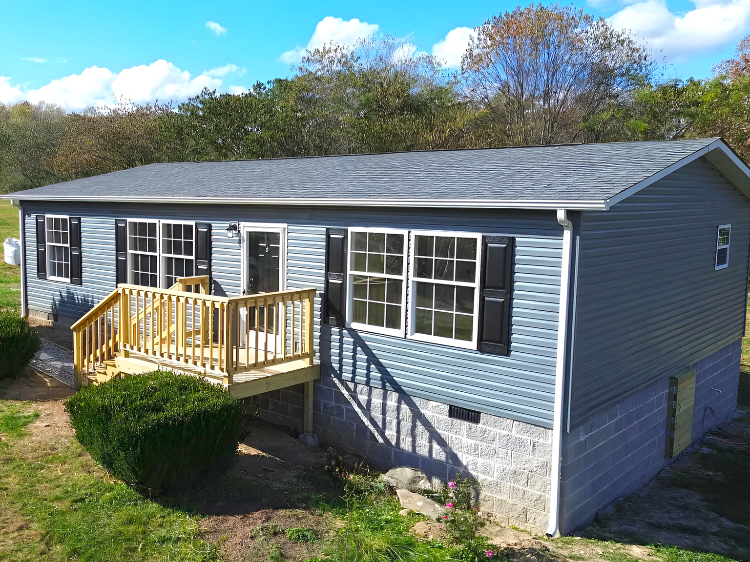 Gray Mobile Home with Black Shutters