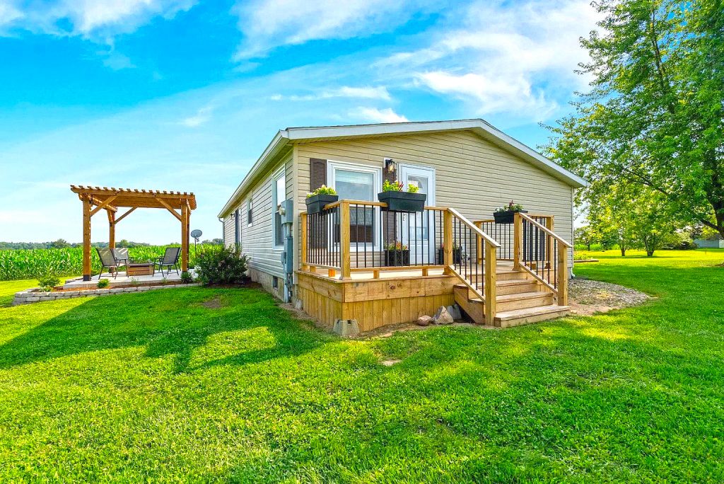 A Stylish Mobile Home Exterior with Front Deck and Back Patio