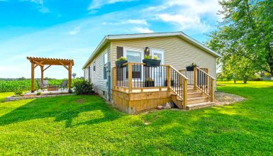 A Stylish Mobile Home Exterior with Front Deck and Back Patio