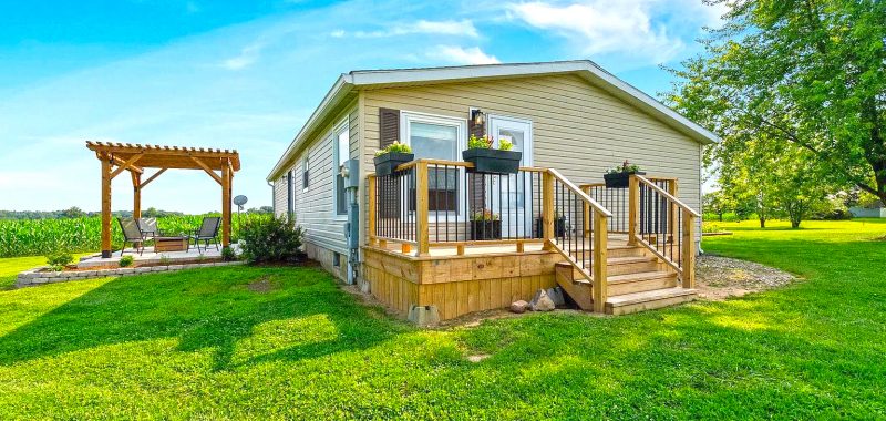 A Stylish Mobile Home Exterior with Front Deck and Back Patio