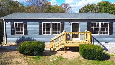 Gray Mobile Home with Black Shutters