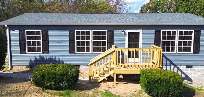 Gray Mobile Home with Black Shutters