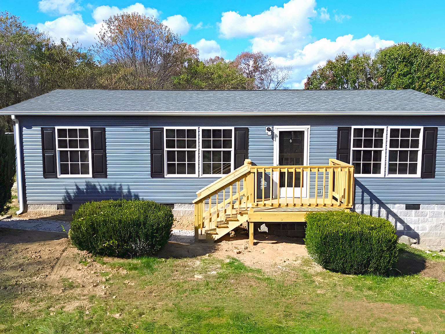 Gray Mobile Home with Black Shutters