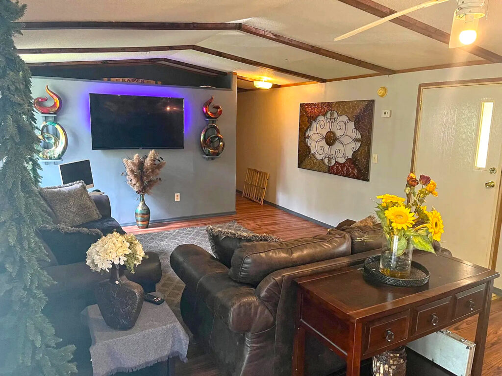 Step Inside This Inviting Single Wide Mobile Home with a Warm Rustic Porch