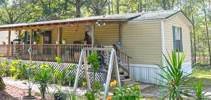 Inviting Single Wide Mobile Home with a Warm Rustic Porch