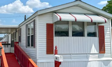 White Single Wide Mobile Home With Cozy Interior and Classic Red Curb Appeal