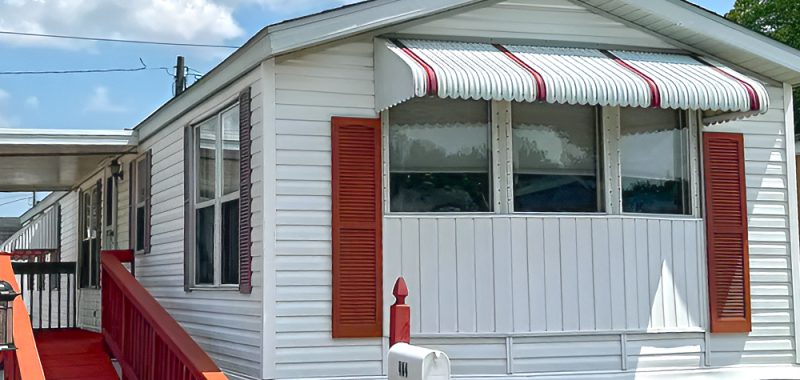 White Single Wide Mobile Home With Cozy Interior and Classic Red Curb Appeal