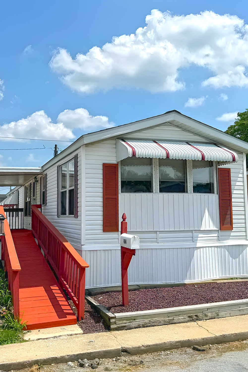 White Single Wide Mobile Home With Cozy Interior and Classic Red Curb Appeal