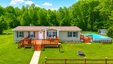 Mobile Home Exterior With a Spacious Deck and Pool